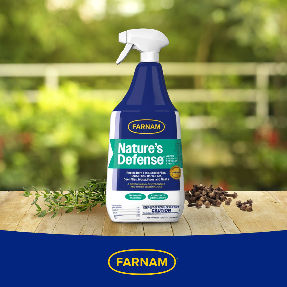 Bottle of farnam natures defense water based botanical fly spray on a wooden table